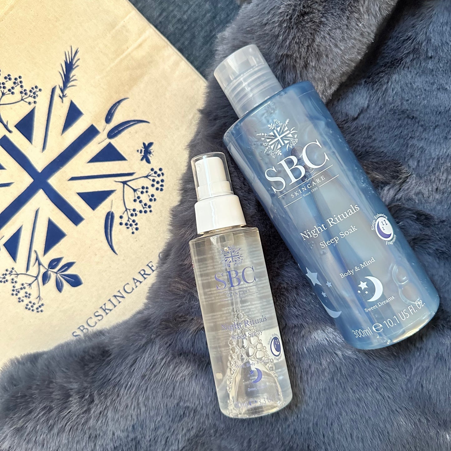 SBC Skincare's Night Rituals Sleep Soak and Spray on a blue fluffy background