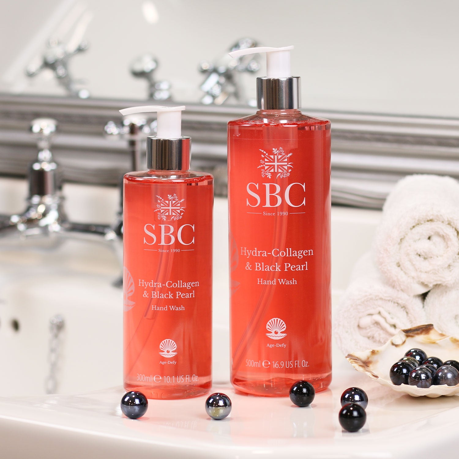 300ml and 500ml Hydra-Collagen & Black Pearl Hand wash on a bathroom sink with black pearls