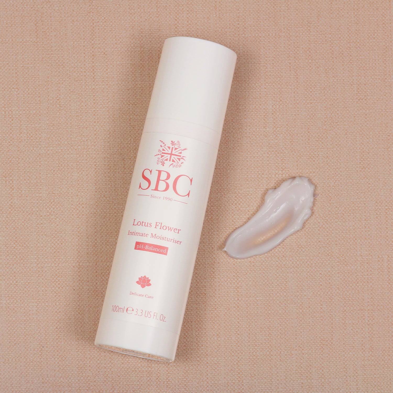 Lotus Flower Intimate Moisturiser on a peach background with a swatch of product