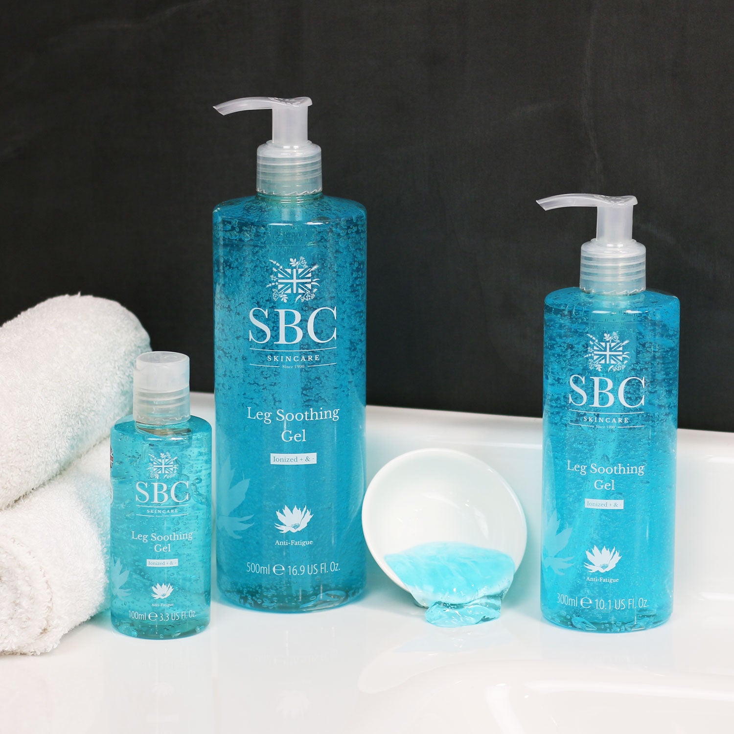 100ml, 300ml and 500ml Leg Soothing Gels on a bathroom sink with a black back splash