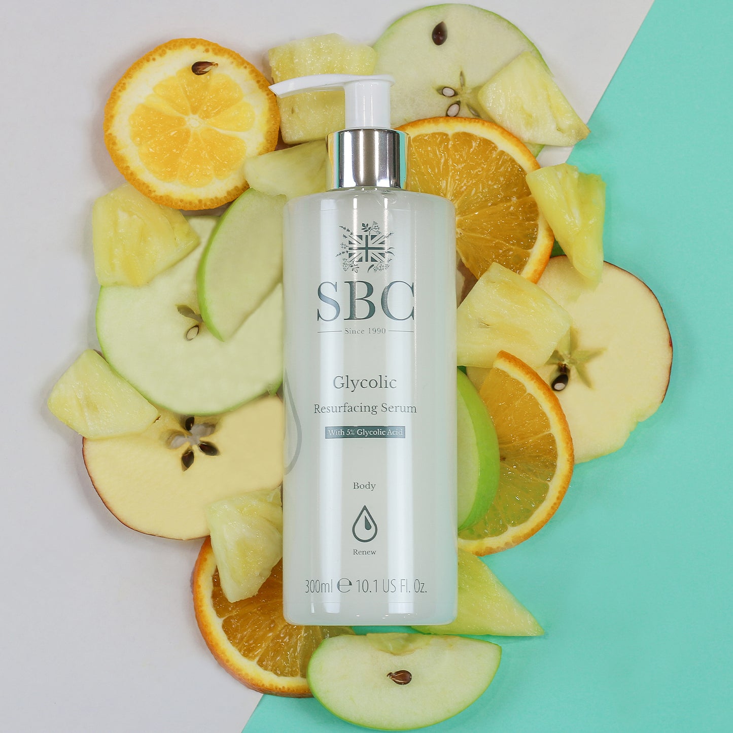 Glycolic Resurfacing Serum laid on a pile of slices of apples, oranges and pineapples