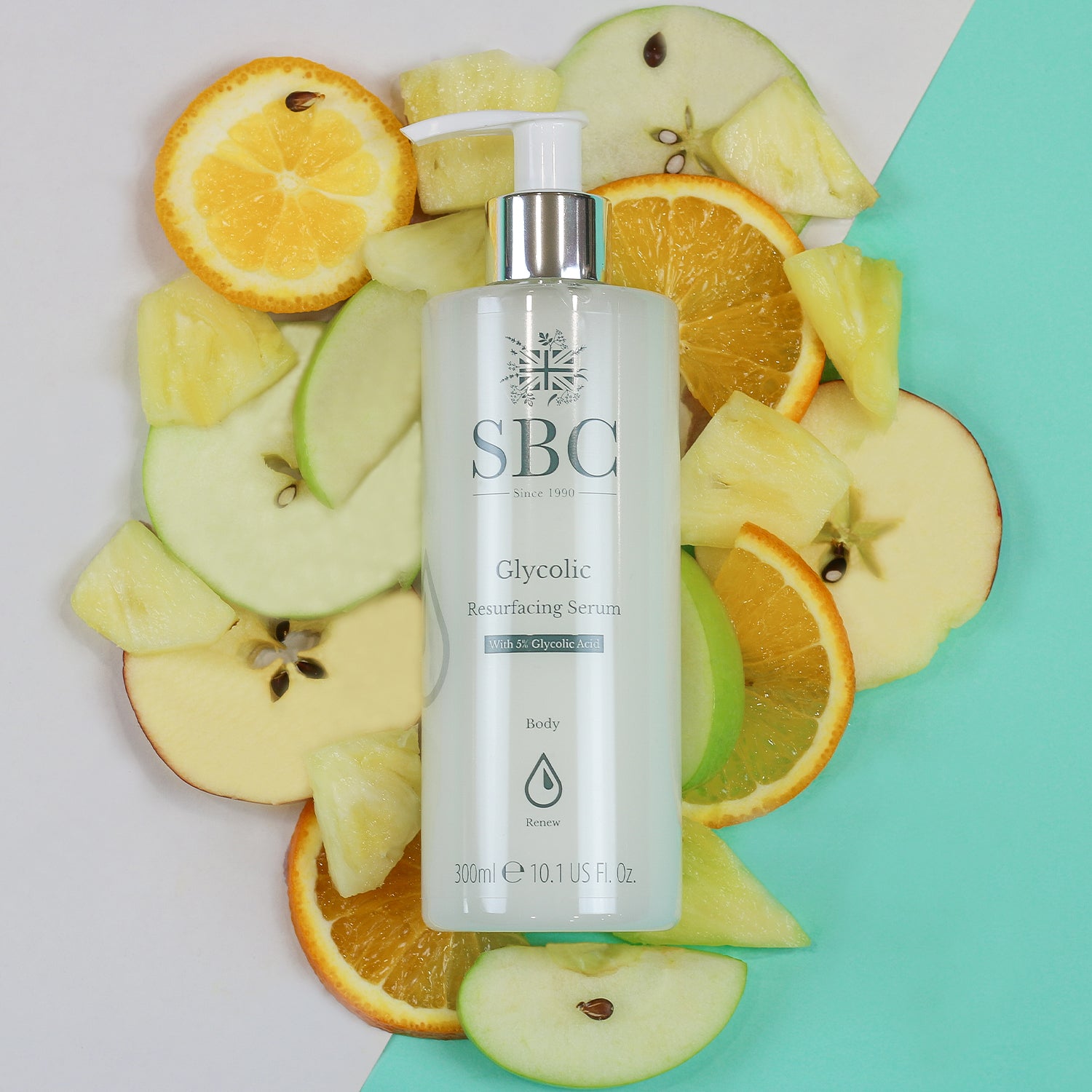 Glycolic Resurfacing Serum laid on a pile of slices of apples, oranges and pineapples