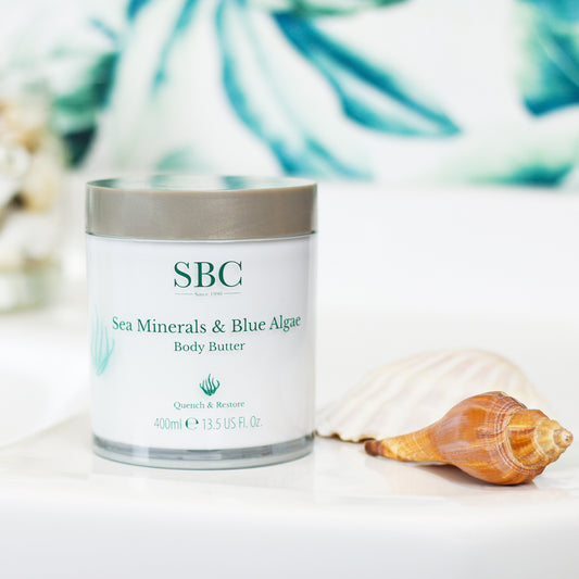 Sea Minerals & Blue Algae Body Butter on a sink with botanical wallpaper in the background