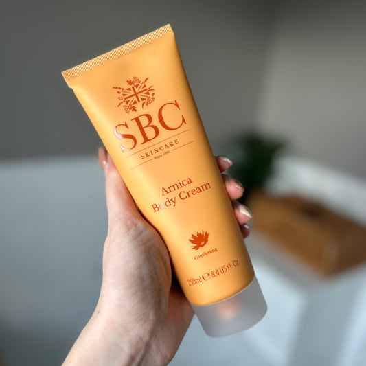 Arnica Body Cream in hand