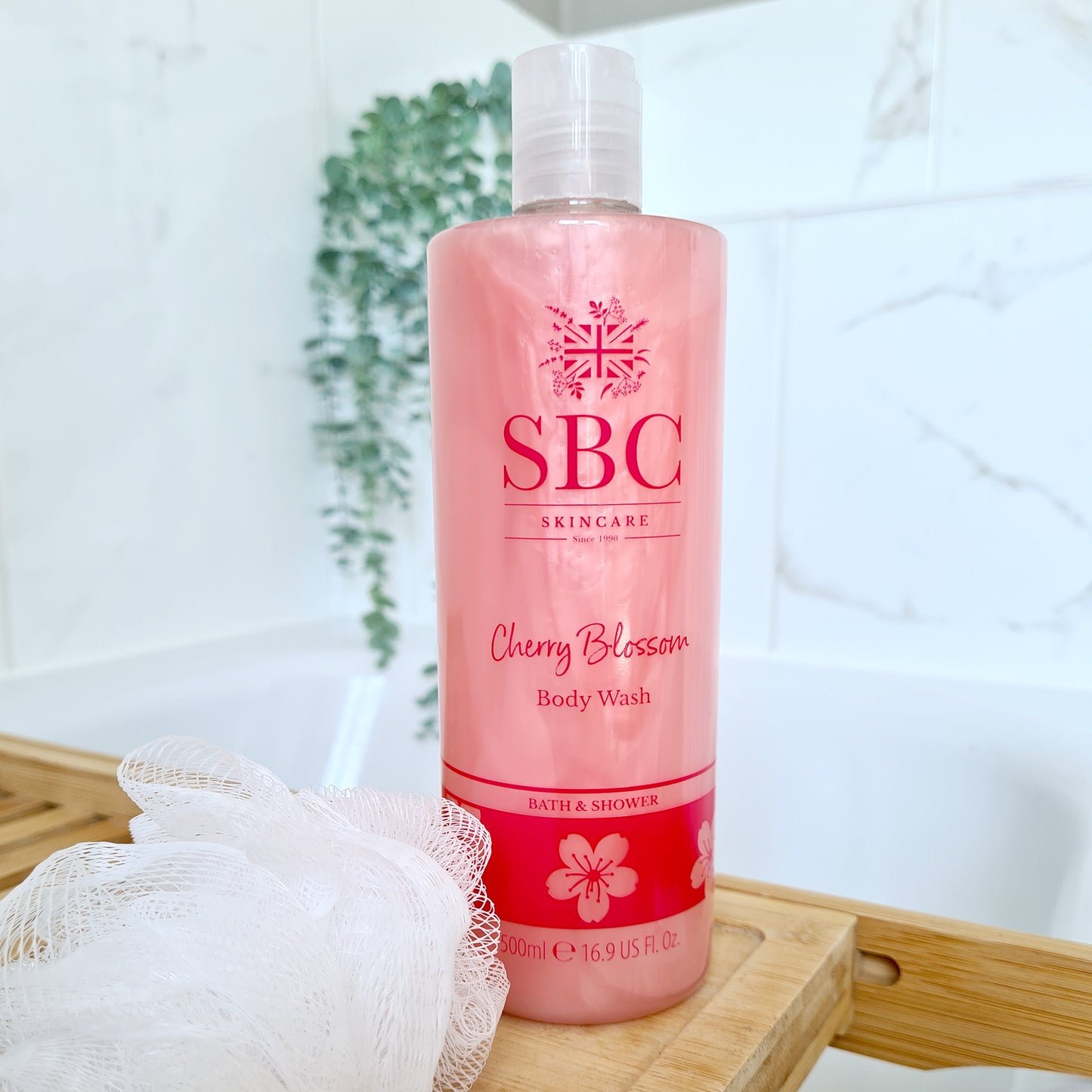 500ml SBC Skincare Cherry Blossom Body Wash on a wooden Bath Caddy 