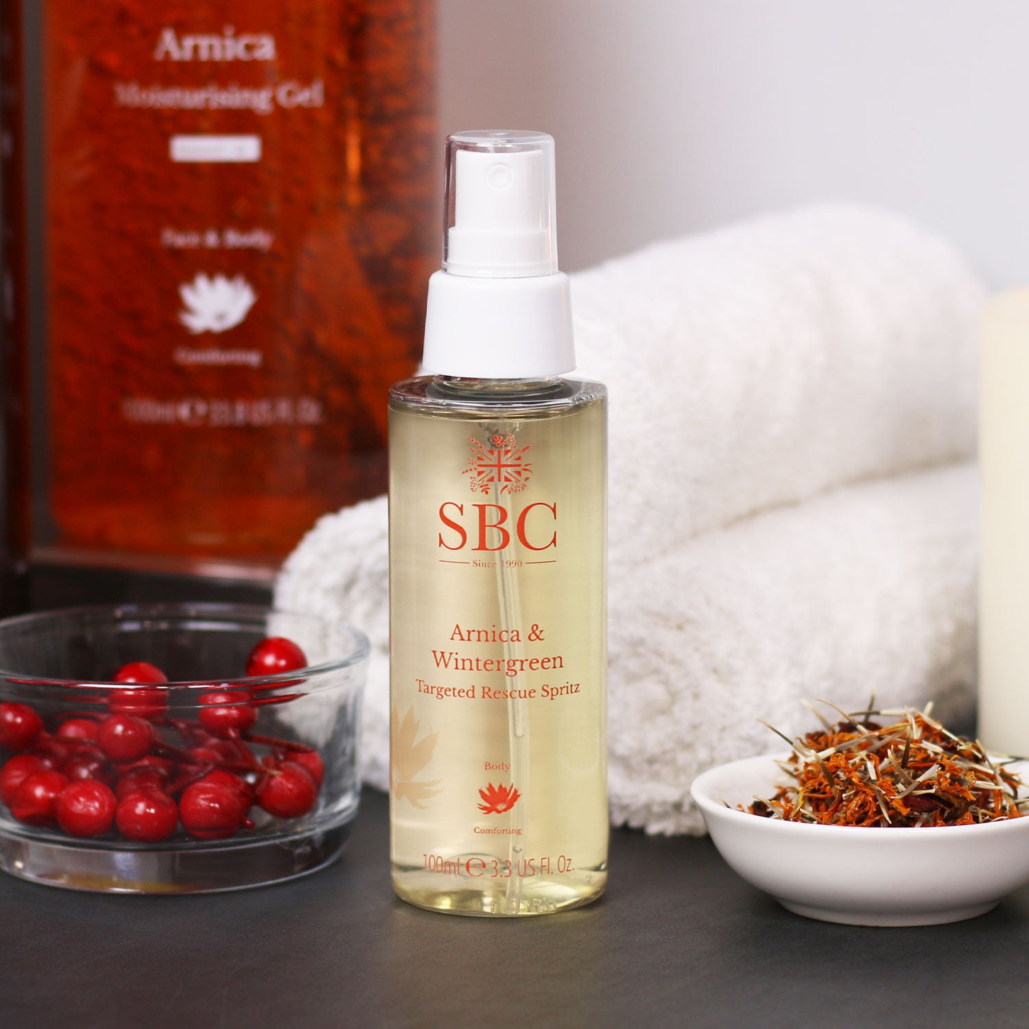 SBC Skncare Arnica & Wintergreen Targeted Rescue Spritz on an orange background