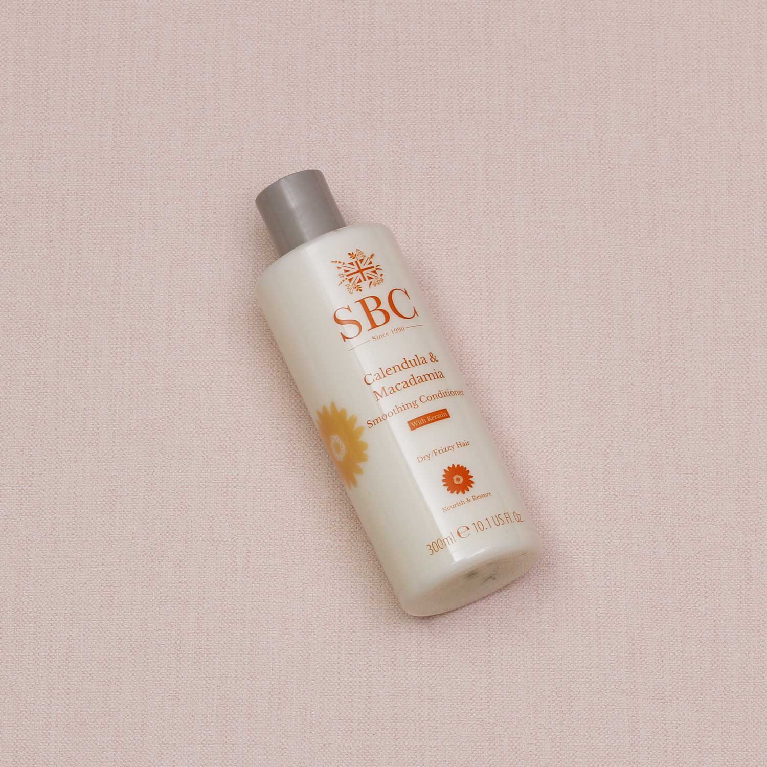 SBC Skincare's Calendula & Macadamia Smoothing Conditioner 300ml on a textured beige background