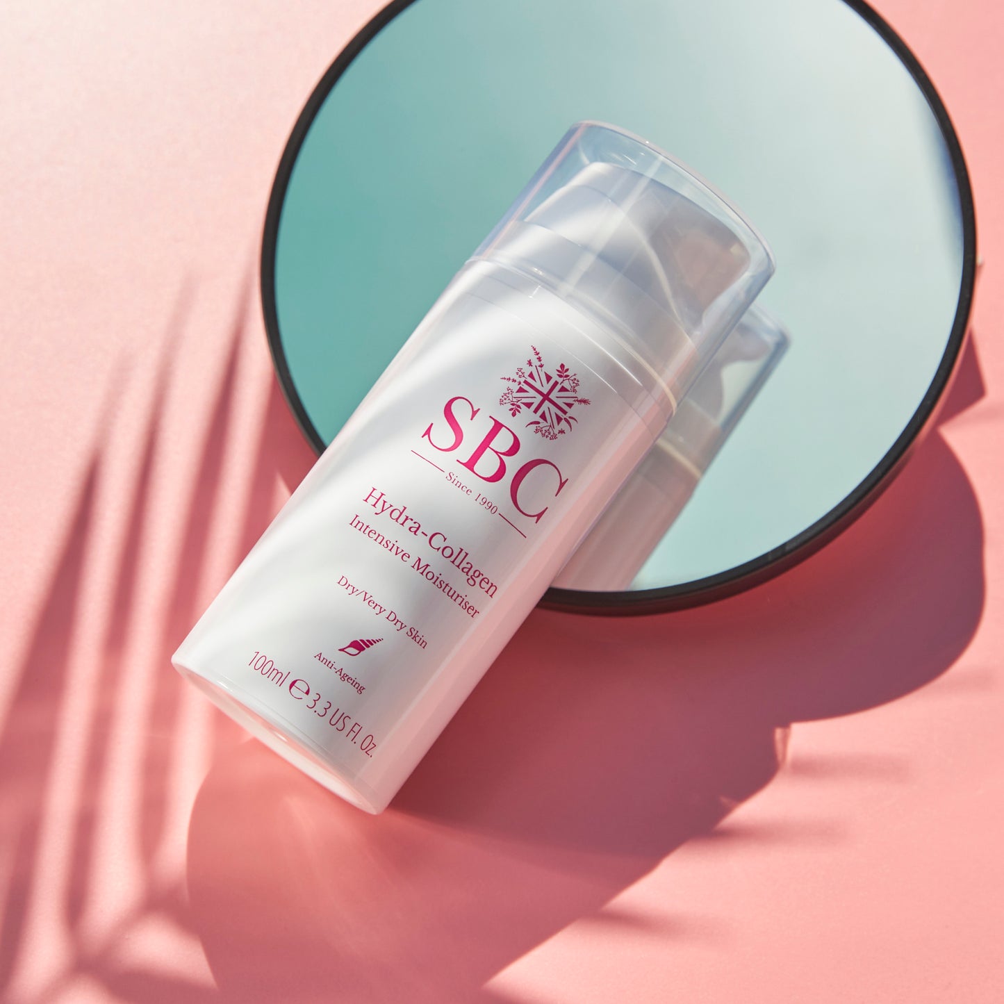 Hydra-Collagen Intensive Moisturiser on a pink surface with palm leaf shadows