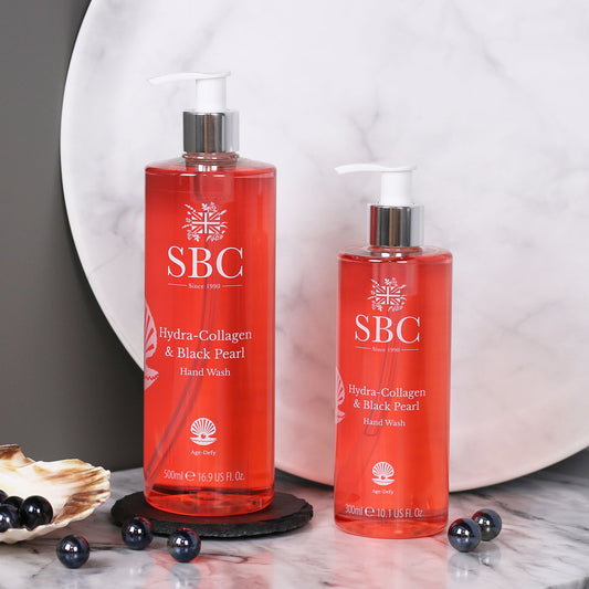 300ml and 500ml Hydra-Collagen & Black Pearl Hand wash on a marble counter with black pearls 