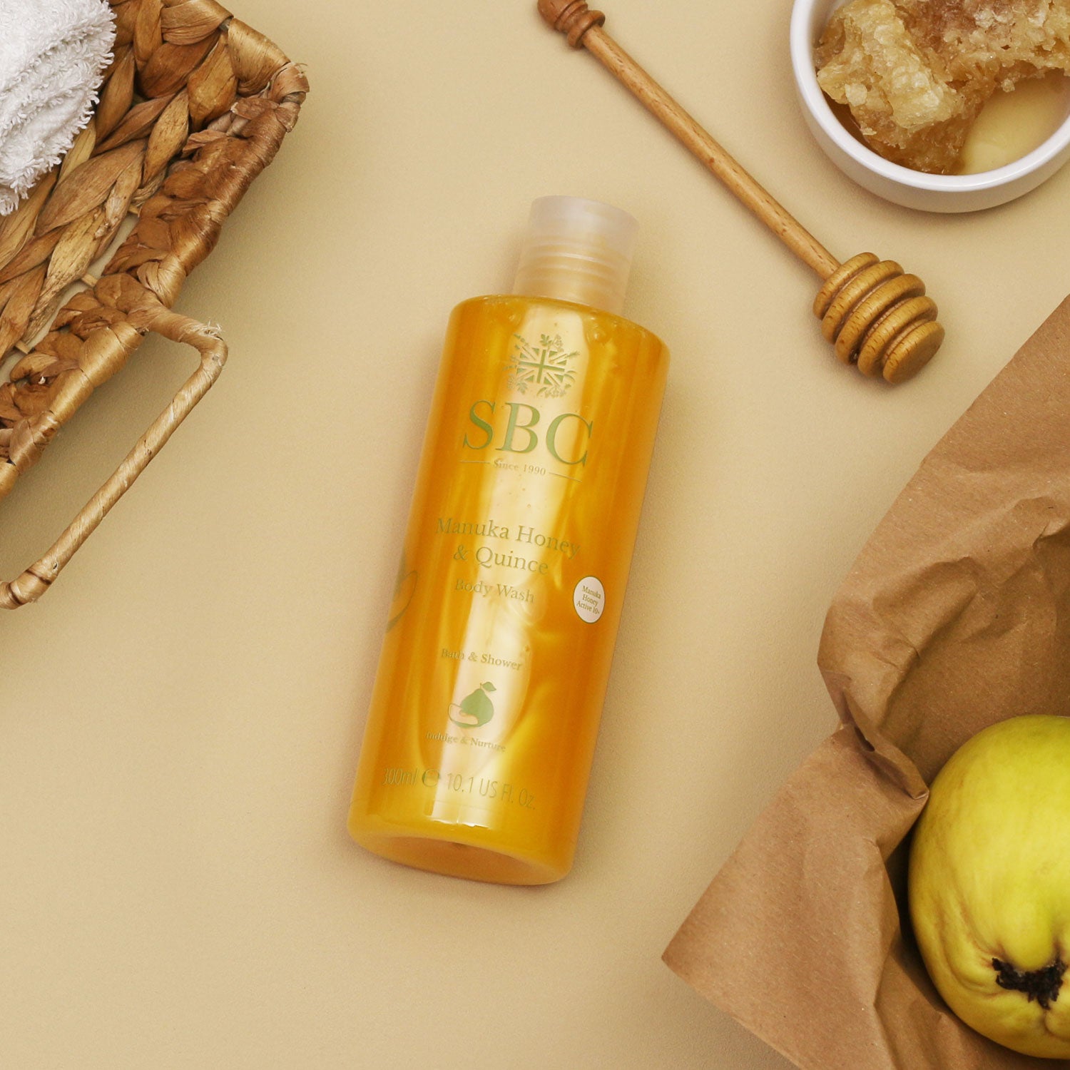 300ml Manuka Honey & Quince Body Wash on brown paper with honey comb and quinces