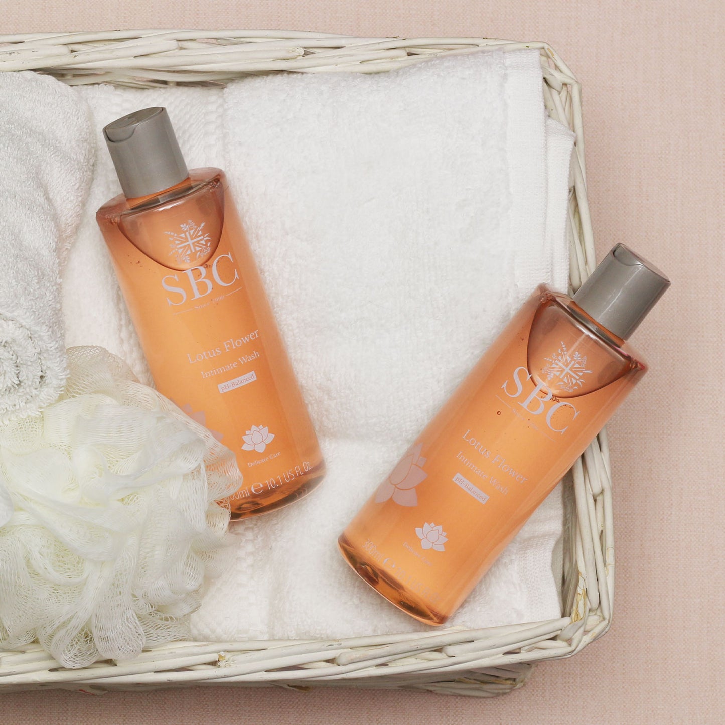 SBC Skincare's Lotus Flower Intimate Washes in a white basket with a towel 