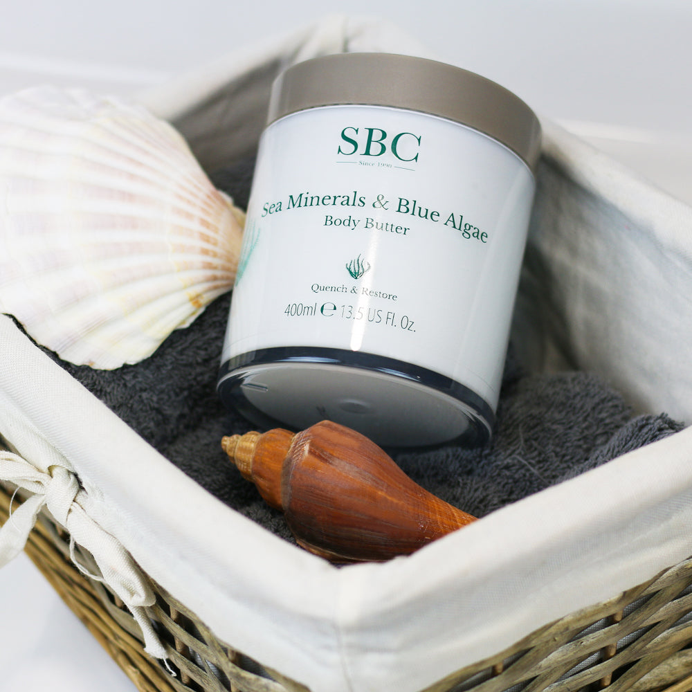 Sea Minerals & Blue Algae Body Butter in a wicker basket with shells 
