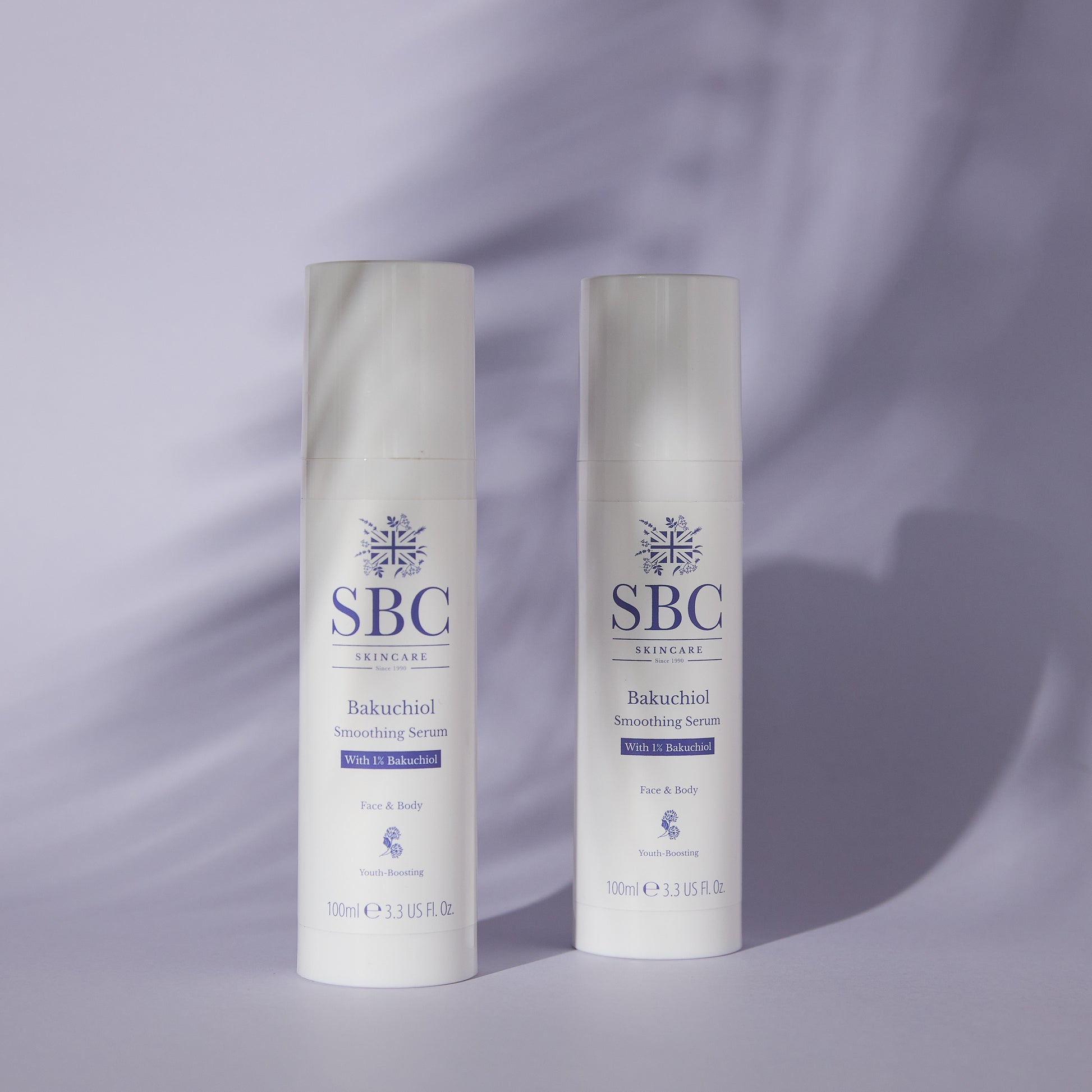 Two Bakuchiol Smoothing Serums on a purple background with leafy shadows 