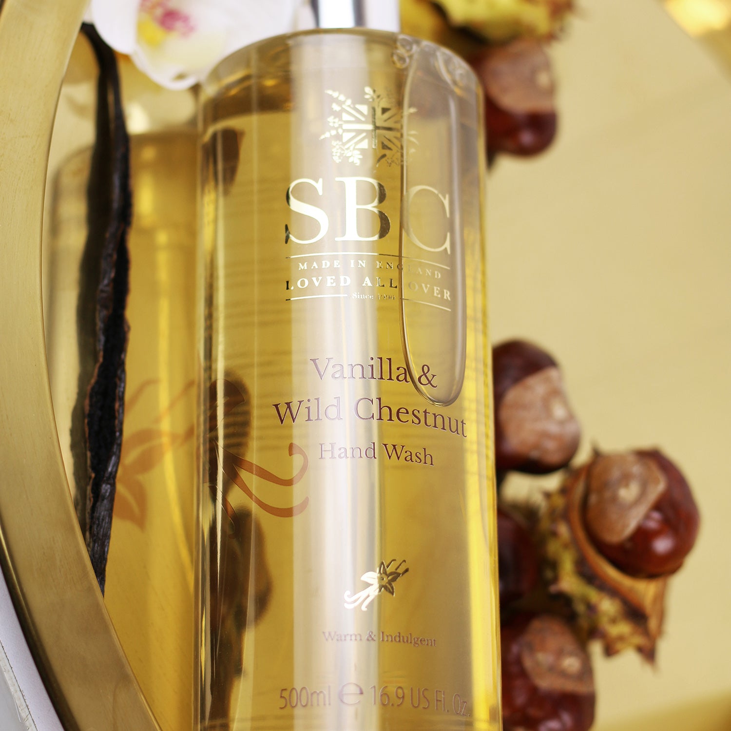 Vanilla & Wild Chestnut Hand Wash on a gold plate with chestnuts 
